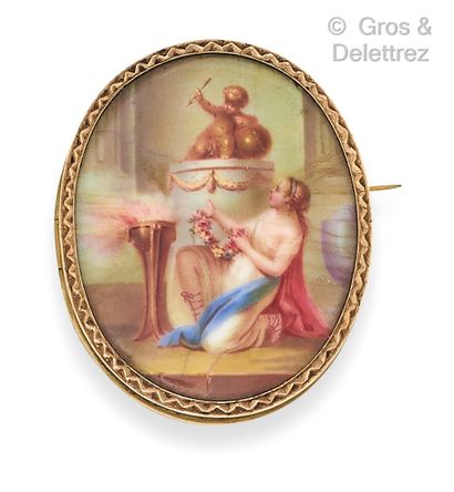 A yellow gold brooch with an enamelled painted...