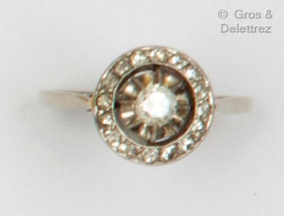 A white gold ring, with a circular motif...