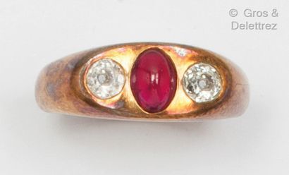 Pink gold ring set with a red stone cabochon...