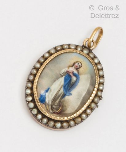 null A yellow gold and silver medallion with a miniature of the Virgin Mary in a...