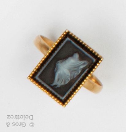 A yellow gold ring with a rectangular cameo...