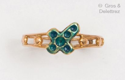 null Yellow gold openwork "Chapelet" ring, decorated with a blue enamelled cross....