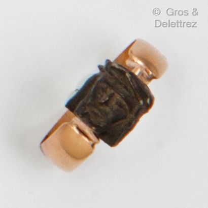 null 
Yellow gold "Memento Mori" ring, set with blackened wood carvings of the head...