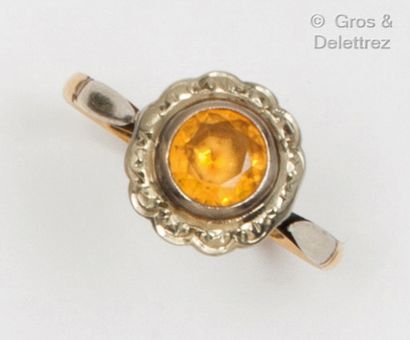 Yellow and white gold ring set with an orange...