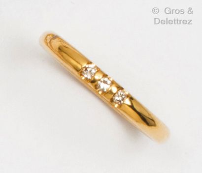 null Yellow gold wedding band set with three brilliant-cut diamonds. Finger size...