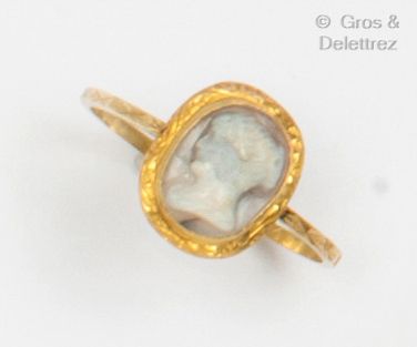 A yellow gold ring with an agate cameo in...