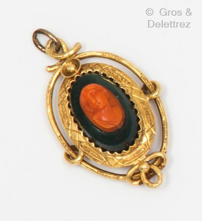 null A yellow gold pendant with a cameo on coral representing a female bust on blood...