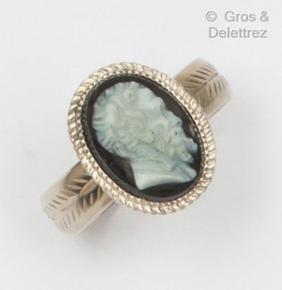 A white gold ring with a cameo on agate representing...