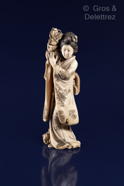 null Japan, circa 1900-1920

Ivory Okimono with brown highlights showing a geisha...