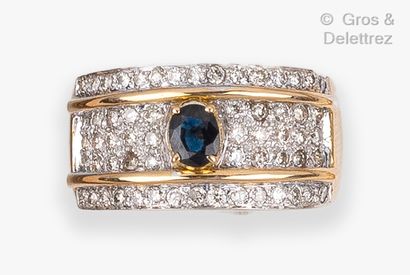 null Yellow gold "Jonc" ring, set with an oval sapphire on a pavé of brilliant-cut...