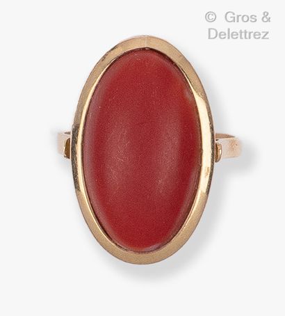 Yellow gold ring set with a cabochon carnelian....