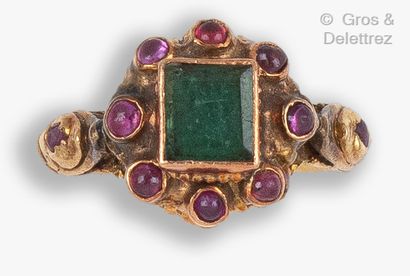 null Yellow gold ring set with a square emerald in a cabochon ruby setting. The ring...