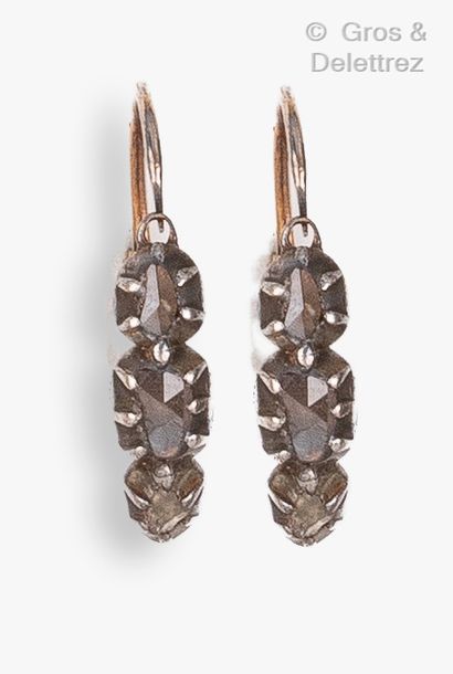 null Pair of yellow gold and silver earrings, each adorned with three rose-cut diamonds....