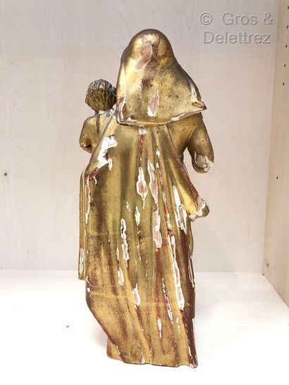 null Sculpture en bois doré figurant la Vierge tenant l'Enfant Jésus portant le globe.

XIXe...