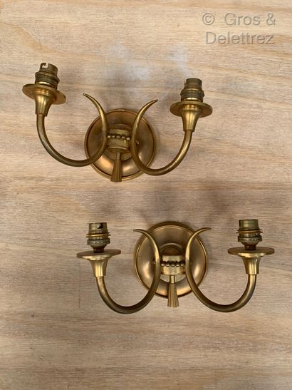  A pair of ormolu sconces with two scrolled arms around a frieze of pearls and stylized...