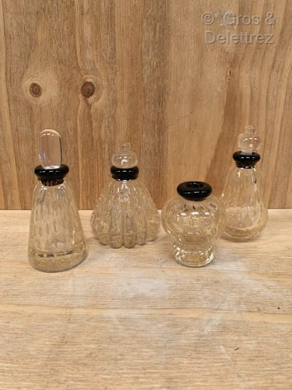  Murano. Suite of four bottles decorated with inclusions of bubbles and gold spangles....