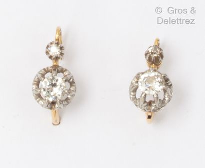 null Pair of yellow gold "Dormeuses" earrings, set with an old cut diamond and a...