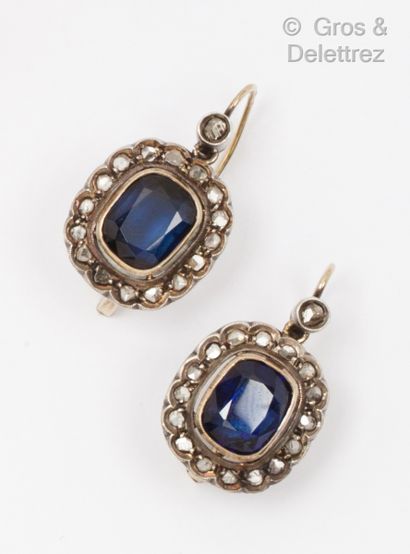  Pair of yellow gold and silver earrings decorated with a flower set with blue stone...
