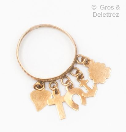Yellow gold (9K) ring with charms representing...