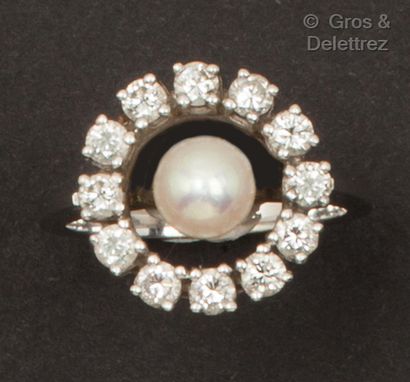 A white gold ring set with a cultured pearl...