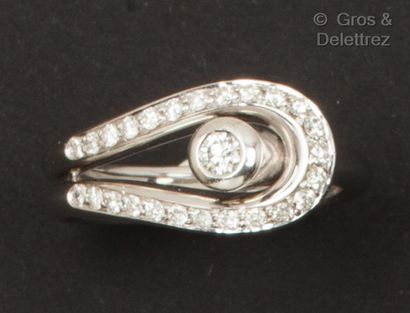 A white gold ring forming a loop, set with...