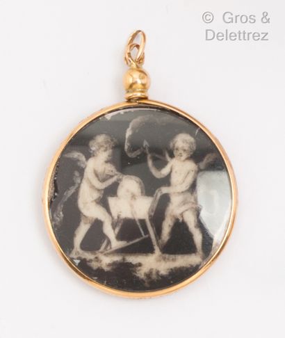 A yellow gold circular pendant with a miniature...
