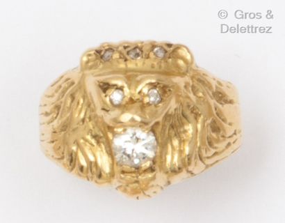 null Lion head" ring in chased yellow gold, holding a brilliant-cut diamond in its...
