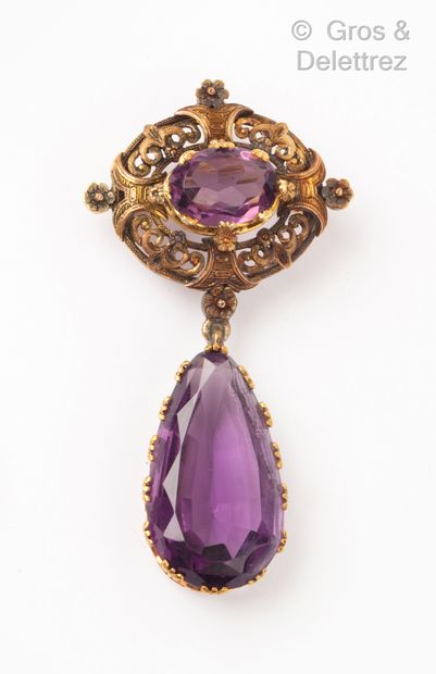 null A yellow gold pendant set with a facetted amethyst in a finely openwork setting...