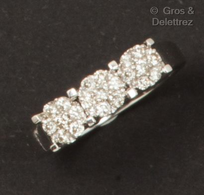 null White gold ring, set with three circular motifs set with brilliant-cut diamonds....