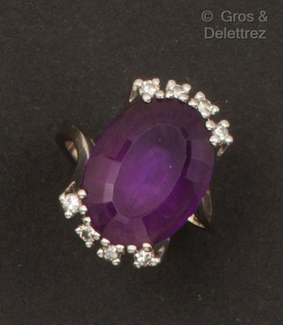 A white gold ring set with an oval amethyst...