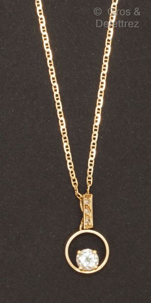 null A yellow gold long necklace with a navy link, holding a circular pendant set...