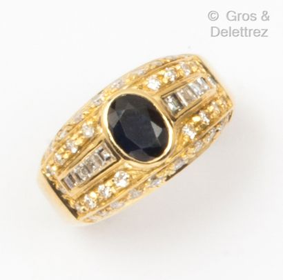 Yellow gold ring set with an oval sapphire...