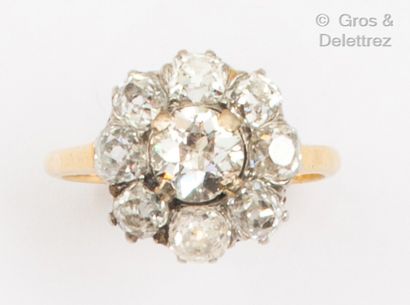 null A platinum and yellow gold "Flower" ring, set with a diamond in a setting of...