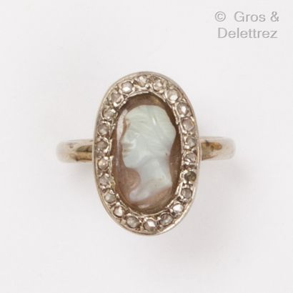 null A white gold and platinum ring set with an agate cameo in a diamond setting....
