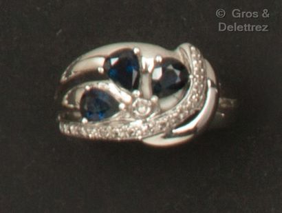 null 
Openwork white gold ring, set with three pear-shaped sapphires SURMONTED BY...
