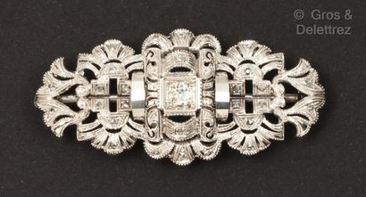 An openwork white gold brooch set with an...
