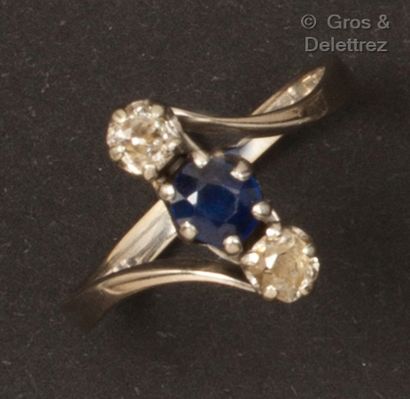 null A white gold ring with an oval sapphire set with old cut diamonds. Finger size...