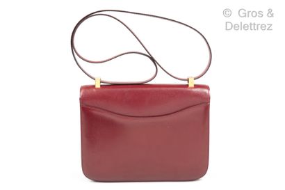 HERMÈS Paris made in France Constance" bag in burgundy box, gilded metal "H" clasp...