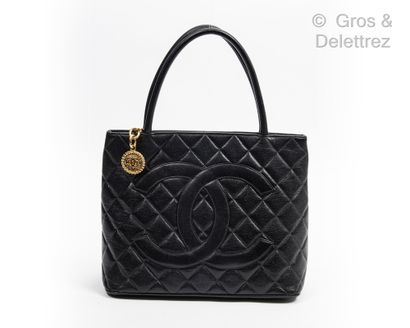 CHANEL Year 1997 
Medallion" bag 30 cm in black quilted caviar calfskin, front decorated...