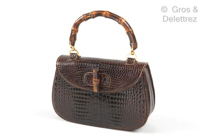 GUCCI Circa 1960

∆ "Bamboo" bag 27 cm in Crocodylus Porosus coffee, bamboo handle,...