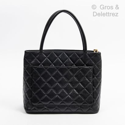 CHANEL Year 1997 
Medallion" bag 30 cm in black quilted caviar calfskin, front decorated...