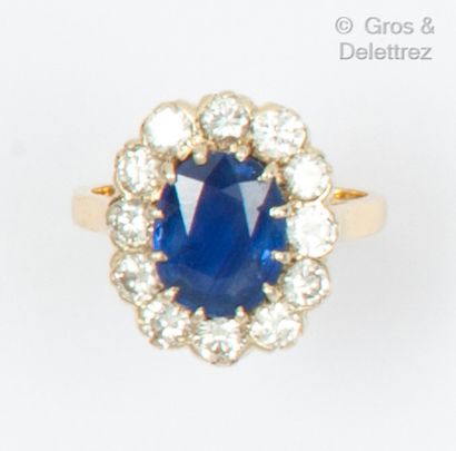null Yellow gold "Flower" ring, set with an oval faceted sapphire in a brilliant-cut...