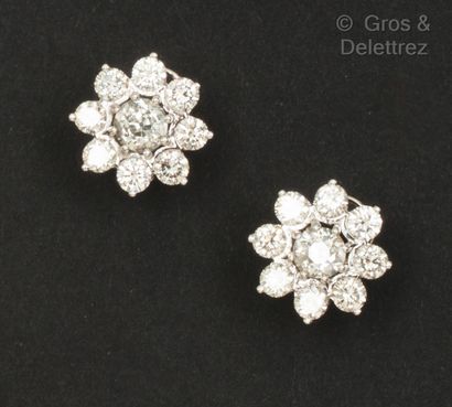 null A pair of white gold "Flower" earrings set with brilliant-cut diamonds, the...