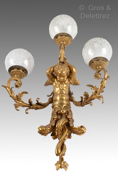 null A pair of important ormolu sconces with three arms, the shaft in the shape of...