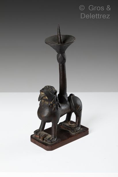 null A bronze pikeman with a crusty patina. The base is formed by a standing lion,...