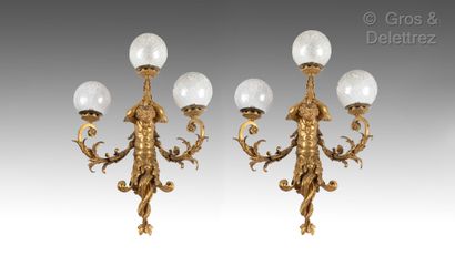 null A pair of important ormolu sconces with three arms, the shaft in the shape of...