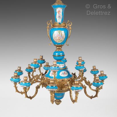 null A twelve arms gilt bronze chandelier in rocaille style decorated with blue enamelled...