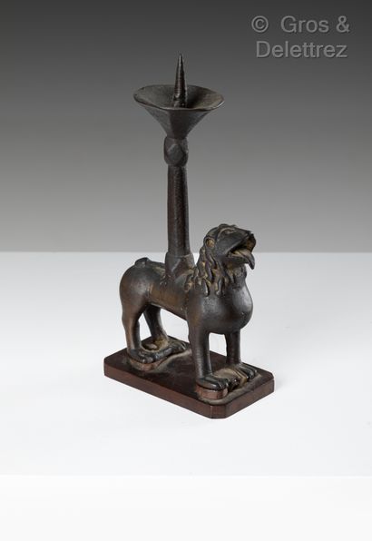 null A bronze pikeman with a crusty patina. The base is formed by a standing lion,...