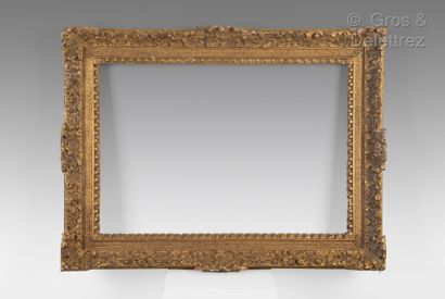 Carved and gilded oak frame with Bérain, sandblasted and denticulated decoration....