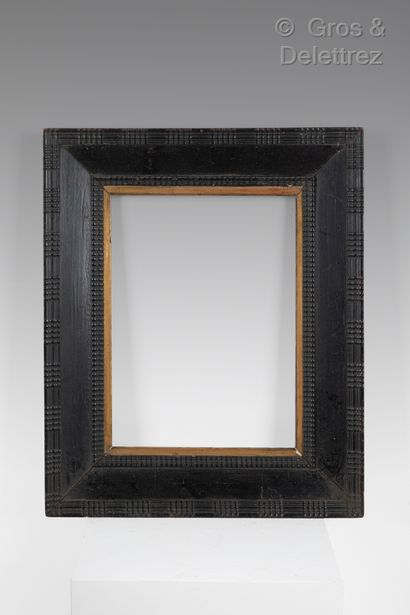 Blackened wood frame with guilloche decoration....